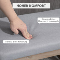 Eine graue Fussbank und Polsterhocker mit Holzbeinen.