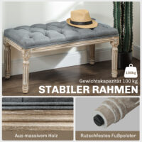 Graue Polsterbank im Vintage-Stil mit eleganter Knopfverzierung. Ein zeitloses Möbelstück für klassische Einrichtungen.