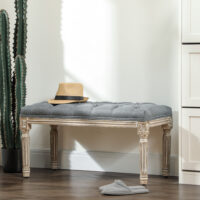 Graue Polsterbank im Vintage-Stil mit eleganter Knopfverzierung. Ein zeitloses Möbelstück für klassische Einrichtungen.
