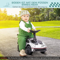 Weiss-schwarzes Rutschauto als Kinderfahrzeug mit Hupe, perfekt für den Einsatz drinnen und draussen.