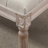 Ein cremeweisser Sitzhocker mit gepolstertem Sitz und Holzbeinen in Leinenoptik.